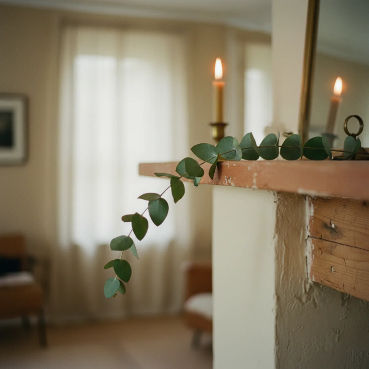 Fireplace mantel decor — fresh evergreen garland draped along mantel with 12 inches of overhang trailing off one end softening the architectural rectangular lines — Home Decor Aura
