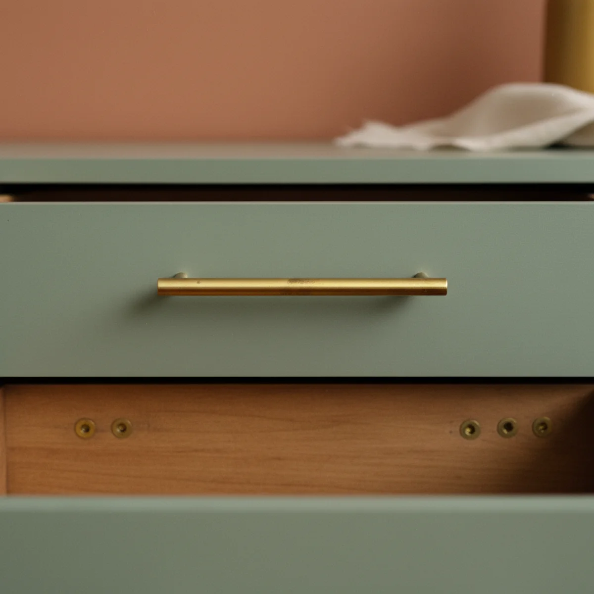 Painted dresser makeover — sage green painted dresser with new unlacquered brass bar pulls installed showing the hardware swap as the final transformative move — Home Decor Aura